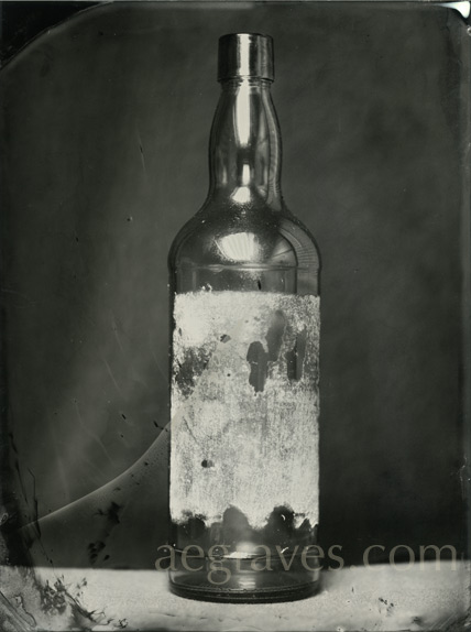 wet collodion image of a dark bottle with glue and paper remnants, Summer 2012, by A.E. Graves
